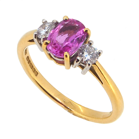  A modern, 18ct yellow gold, pink sapphire & diamond set three stone ring