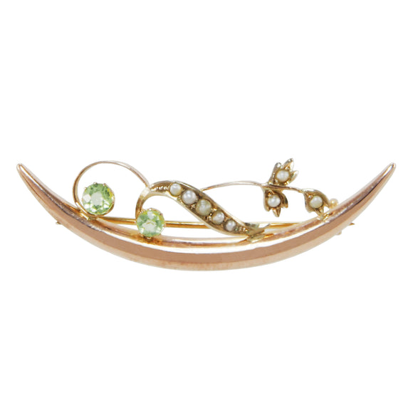  An Edwardian, 9ct yellow gold, peridot & seed pearl set, floral crescent brooch