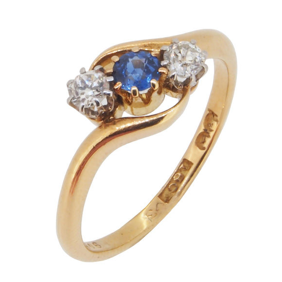  WEEK.  An early 20th century, 18ct yellow gold, sapphire & diamond set, three stone crossover ring