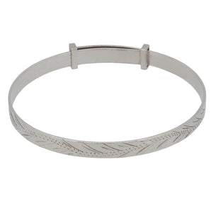 A modern, silver child's expanding bangle with an engraved scrolling design.