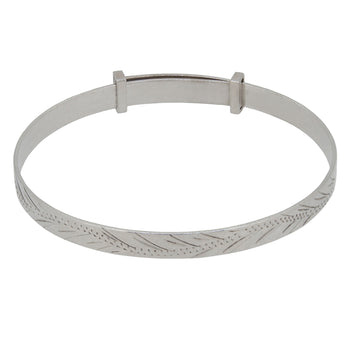 A modern, silver child's expanding bangle with an engraved scrolling design.