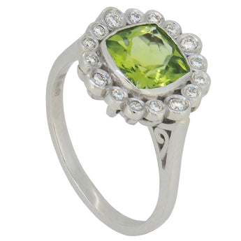 A modern, platinum, peridot & diamond set cluster ring.
