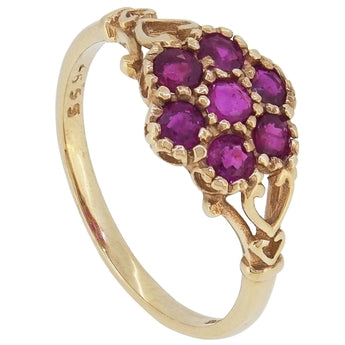 A modern, 9ct yellow gold, ruby set, seven stone cluster ring.