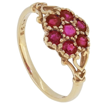A modern, 9ct yellow gold, ruby set, seven stone cluster ring.