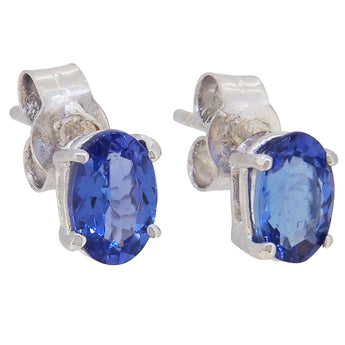 A pair of modern, 9ct white gold, tanzanite set stud earrings.