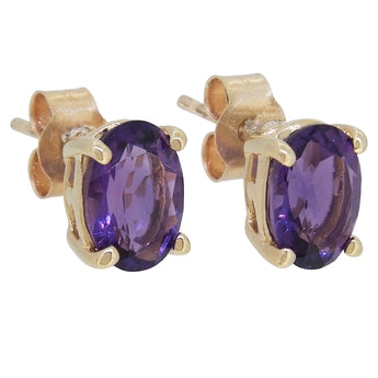 A pair of modern, 9ct yellow gold, amethyst set stud earrings.