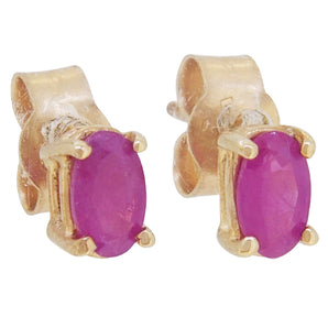 A pair of modern, 9ct yellow gold, ruby set stud earrings.