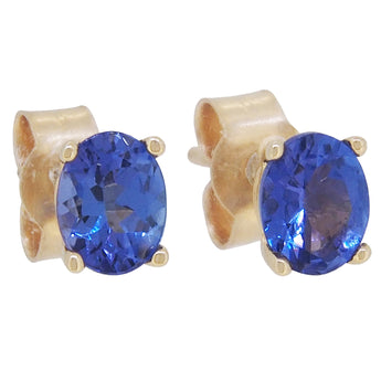 A pair of modern, yellow gold, tanzanite set, oval stud earrings.