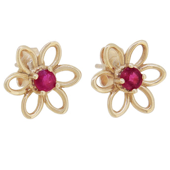 A pair of modern, yellow gold, ruby set stud earrings.