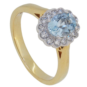 A modern, 18ct yellow gold, aquamarine & diamond set cluster ring.