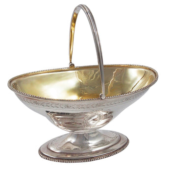 A modern, silver, oval sweet basket with a gilt bowl on a pedestal base.