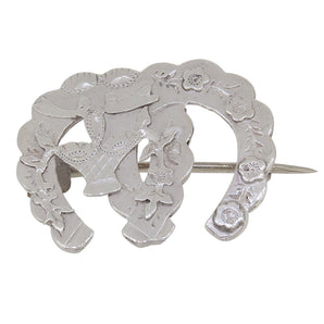 A Victorian, silver, floral, double horseshoe brooch with floral decoration