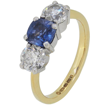 A modern, 18ct yellow gold, sapphire & diamond set three stone ring