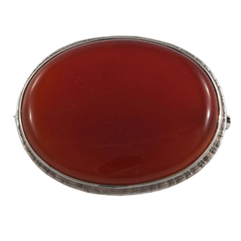 A silver, oval, brown carnelian set brooch