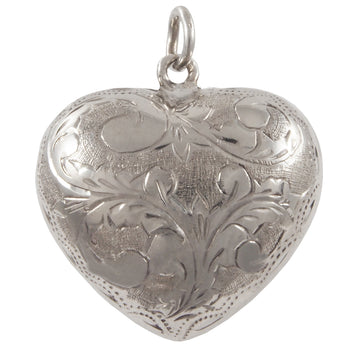 A modern, silver, fully engraved, heart shaped pendant