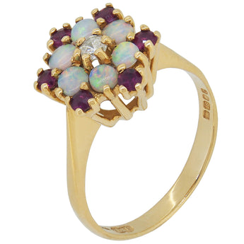 A modern, 18ct yellow gold, opal, ruby & diamond set cluster ring.