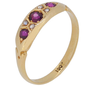 An early 20th century, 18ct yellow gold, ruby & diamond gypsy set, seven stone ring.