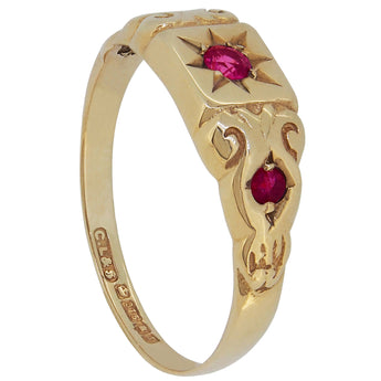 A modern, 9ct yellow gold, ruby, star set, three stone ring