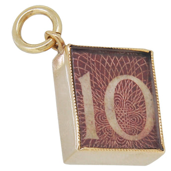 A mid-20th century, 9ct yellow gold, Ten Shilling note charm pendant.