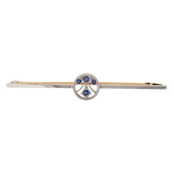 A modern, platinum, sapphire set bar brooch with a 15ct yellow gold pin.