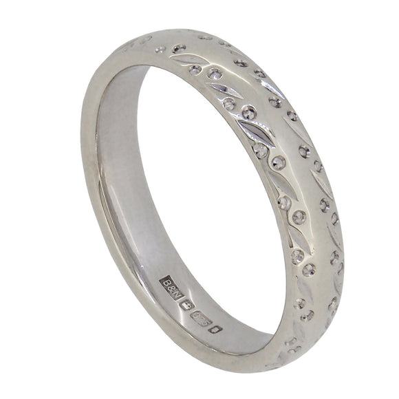 A modern, 9ct white gold, engraved, court wedding ring