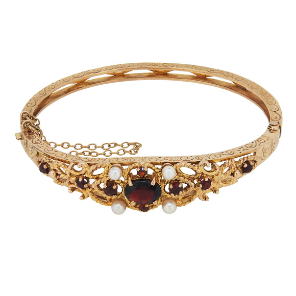 A modern, 9ct yellow gold, garnet & pearl set hinged bangle