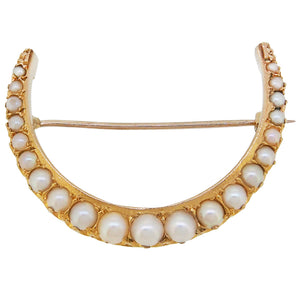A Victorian, yellow gold, half pearl set crescent brooch