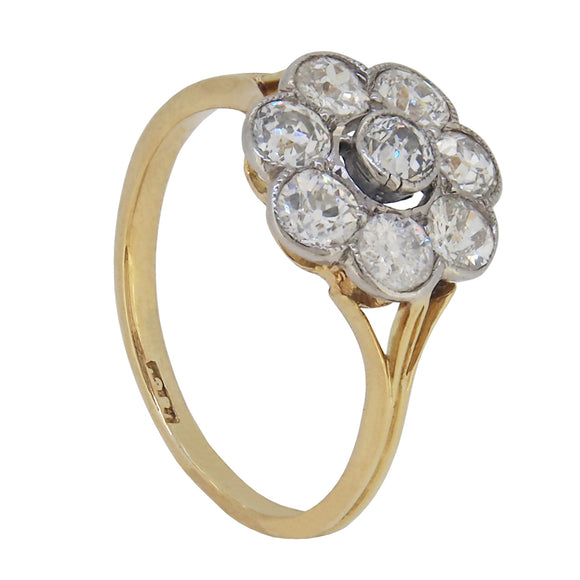 An early 20th century, 18ct yellow gold, diamond set, nine stone daisy cluster ring