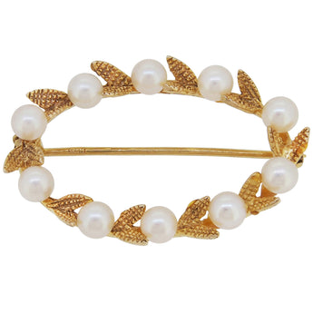 A mid-20th century, 9ct yellow gold, pearl set, ten stone, oval, open work, laurel leaf brooch