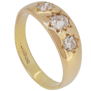 A modern, 18ct yellow gold, old cut diamond gypsy set, three stone ring.