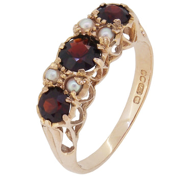 A modern, 9ct yellow gold, garnet & pearl set seven stone ring.