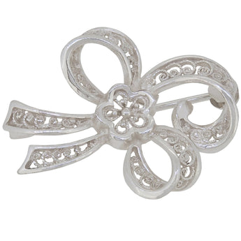 A modern, silver, filigree bow brooch