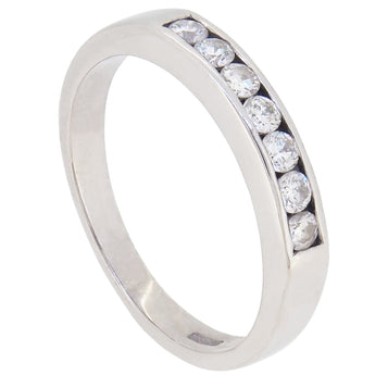 A modern, 9ct white gold, diamond set, channel set, seven stone, half eternity ring.