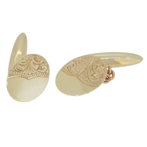 A pair of mid-20th century, 9ct yellow gold, oval, chain link cufflinks with engraved foliate decoration & torpedo toggles.