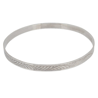 A mid-20th century, silver, flat bangle with an engraved leaf pattern design.