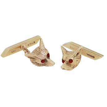 A pair of mid-20th century, 9ct yellow gold, fox head, chain link cufflinks with ruby set eyes.