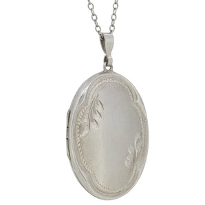 A modern, silver, oval locket & chain