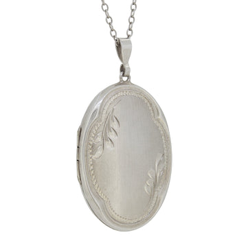 A modern, silver, oval locket & chain