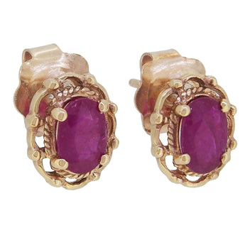 A pair of modern, 9ct yellow gold, ruby set stud earrings.