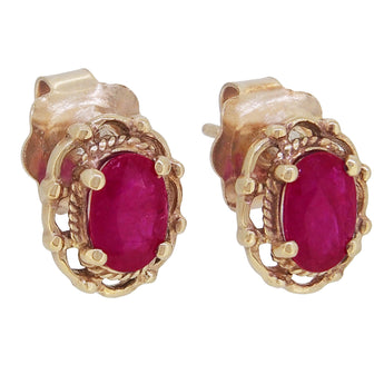 A pair of modern, 9ct yellow gold, ruby set stud earrings.