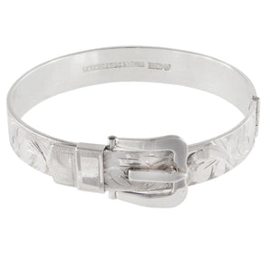 A mid-20th century, silver, flat buckle bangle with an engraved foliate design.
