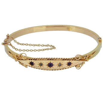 An Edwardian, 9ct yellow gold, amethyst & rose cut diamond set, five stone hinged bangle.