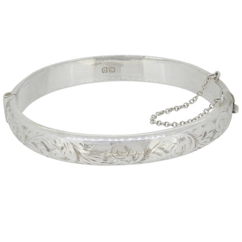 A mid-20th century, silver, half engraved hinged bangle.