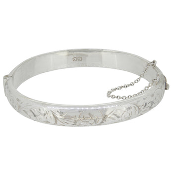 A mid-20th century, silver, hinged bangle with an engraved foliate design.