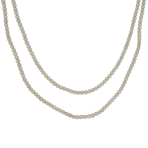 An early 20th century, two row cultured pearl necklet with an 18ct white gold, diamond set, three stone snap.