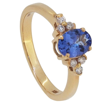 A modern, 18ct yellow gold, tanzanite & diamond set, seven stone ring.