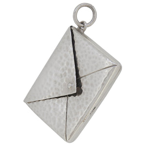 An early 20th century, silver, envelope stamp case pendant.