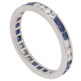 A mid-20th century, 18ct white gold, sapphire & diamond set eternity ring.