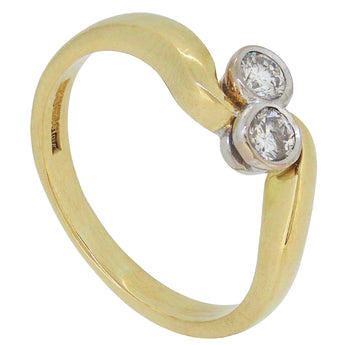 A modern, 18ct yellow gold, diamond set crossover ring.
