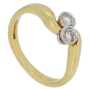 A modern, 18ct yellow gold, diamond set crossover ring.